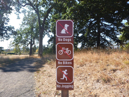 Sign of refuge rules at the start of trail to bus stop “no dogs, no bikes, no jogging”